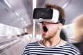 Man wearing virtual reality goggles. Subway escalator. Royalty Free Stock Photo