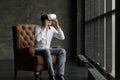 Man wearing virtual reality goggles watching movies or playing video games. The vr headset design is generic and no logos Royalty Free Stock Photo