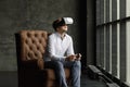 Man wearing virtual reality goggles watching movies or playing video games. The vr headset design is generic and no logos Royalty Free Stock Photo