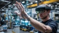 Man Wearing Virtual Reality Headset Interacting with Digital Interface in Industrial Environment Royalty Free Stock Photo