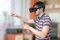 Man is wearing vr glasses and touching something