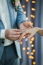 Man wearing wedding ring on woman hand close up. Wedding ceremony vows. Royalty Free Stock Photo