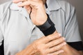 Man wearing a wrist brace or wrap on his left hand and wrist Royalty Free Stock Photo