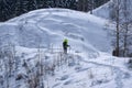 A man wearing yellow jacket enjoying the view of a beautiful winter landscape.