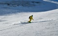 Man wearing yellow suit snowboarding down at extreme double diamond area at Emperial bowl. Royalty Free Stock Photo
