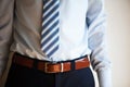 Man wears belt. Young businessman in casual suit with accessories. Fashion and clothing concept. Groom getting ready in Royalty Free Stock Photo