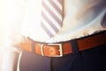 Man wears belt. Young businessman in casual suit with accessories. Fashion and clothing concept. Groom getting ready in Royalty Free Stock Photo