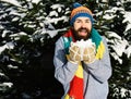 Man wears knitted hat, scarf, gloves. Guy with happy face Royalty Free Stock Photo