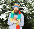 Man wears knitted hat, scarf and gloves with happy face. Royalty Free Stock Photo