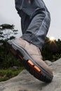 A man wears shoes on the rocks when camping and hiking Royalty Free Stock Photo
