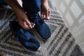 Man wears shoes in the room on the carpet Royalty Free Stock Photo