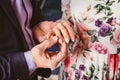 A man wears a wedding ring on the finger of the bride Royalty Free Stock Photo