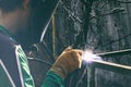 A man in weld mask with weld in his hand during weld job