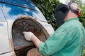 Man - welder in a protective mask