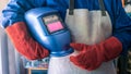 A man welder with safety helmet working with arc welding machine in the workshop Royalty Free Stock Photo