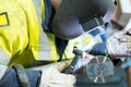 man in welders mask at work