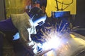 Man welding metal tank