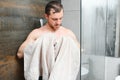 Man with wet hair hold towel after shower. Morning washing, wake up, everyday life. Refreshment, healthcare. Hygiene Royalty Free Stock Photo