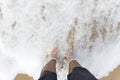 Man wet his legs in the sea water.