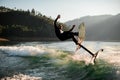 man in wetsuit on foil wakeboard falling from wave Royalty Free Stock Photo