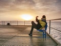 Man on wharf and photograph morning sea