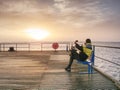 Man on wharf and photograph morning sea