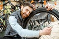 Man with wheel at the bicycle shop Royalty Free Stock Photo