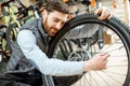 Man with wheel at the bicycle shop Royalty Free Stock Photo