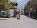 A man in a wheelchair is driving on the road