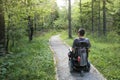 Man on a wheelchair in a forest.