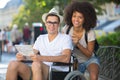 Man in wheelchair and girlfriend on holidays Royalty Free Stock Photo