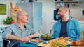 Man in wheelchair having dinner Royalty Free Stock Photo