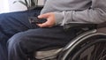 Man on wheelchair looking TV Royalty Free Stock Photo