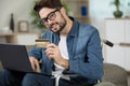 Man in wheelchair making online purchase on laptop Royalty Free Stock Photo