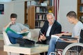 Man in wheelchair meeting in lobby