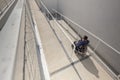 Man in a wheelchair moving along an accessibility pathway Royalty Free Stock Photo
