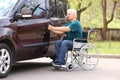 Man in wheelchair opening door of his van Royalty Free Stock Photo