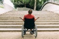 Man in wheelchair outraged in front of stairs