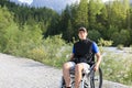 Man in wheelchair outside in nature