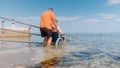Man on wheelchair on ramp to sea Royalty Free Stock Photo