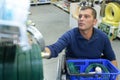 Man in wheelchair shopping in hardware store Royalty Free Stock Photo