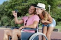 man in wheelchair taking selfie with girlfriend Royalty Free Stock Photo