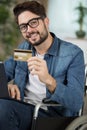 man on wheelchair texting card details Royalty Free Stock Photo