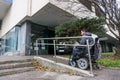 Man in a wheelchair using a ramp next to stairs Royalty Free Stock Photo