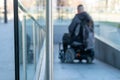 Man in a electric wheelchair using a ramp in blur Royalty Free Stock Photo