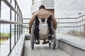 Man in Wheelchair using Ramp Rear View Royalty Free Stock Photo