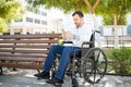 Man in wheelchair using a smartphone Royalty Free Stock Photo