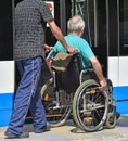 Man in wheelchair waits for the tram