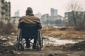 A man in a wheelchair walks along the street in the city. An old man is sitting in a wheelchair on a walk in the city, rear view,