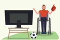 Man in wheelchair watch soccer on TV